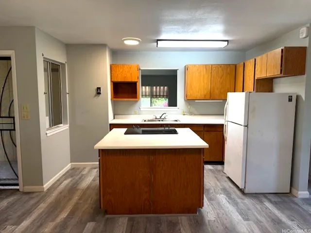 a kitchen with refrigerator a stove a sink and a refrigerator
