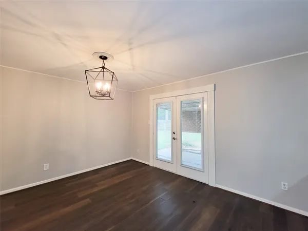 a view of a room with wooden floor and white walls