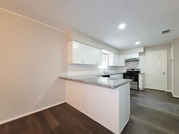 a kitchen with a sink and cabinets