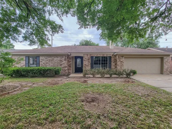 a front view of a house with yard patio and green space