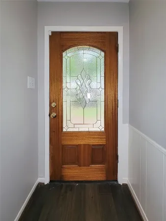 an empty room with wooden floor and a window