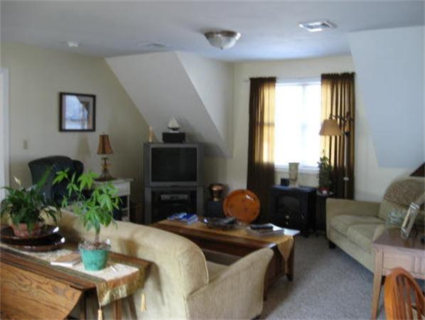 13 Black Point Road Webster, MA 01570 - Photo 10 of 22 a living room with furniture a flat screen tv and a large window