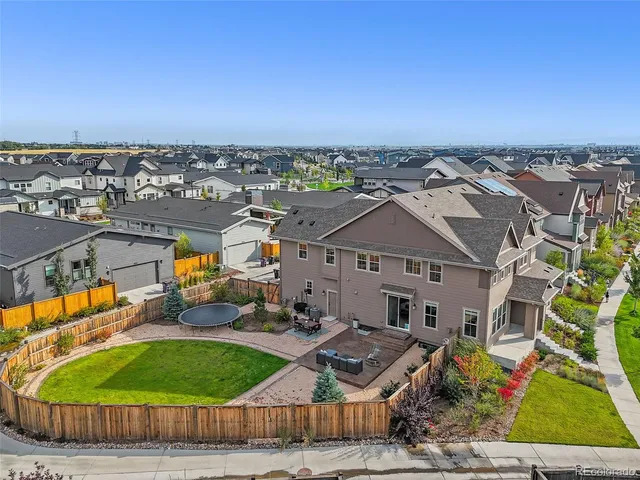 an aerial view of a house with a garden and trees