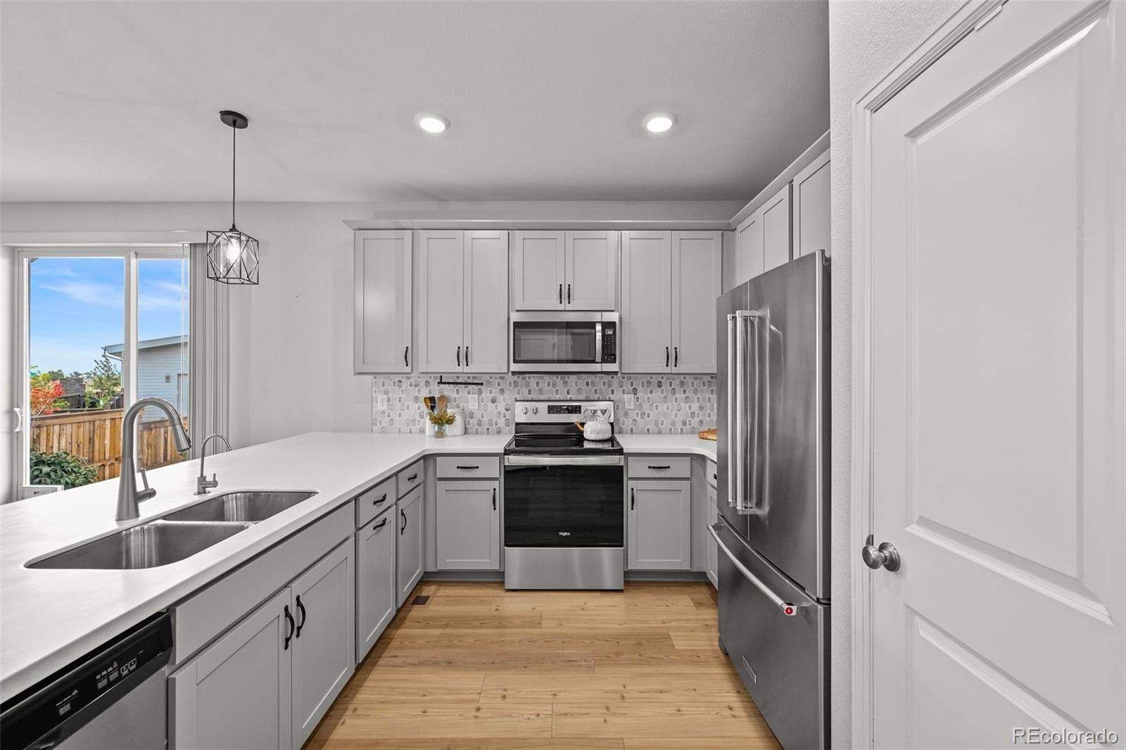6374 North Fulton Street Denver, CO 80238 - Photo 12 of 49 a kitchen with stainless steel appliances granite countertop a sink stove and refrigerator