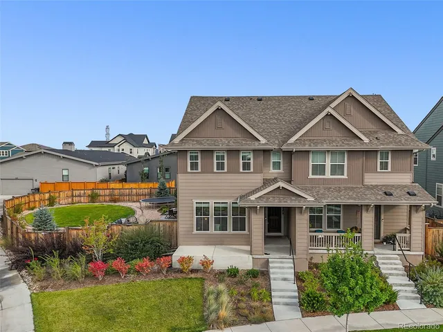 a front view of a house with a garden and plants