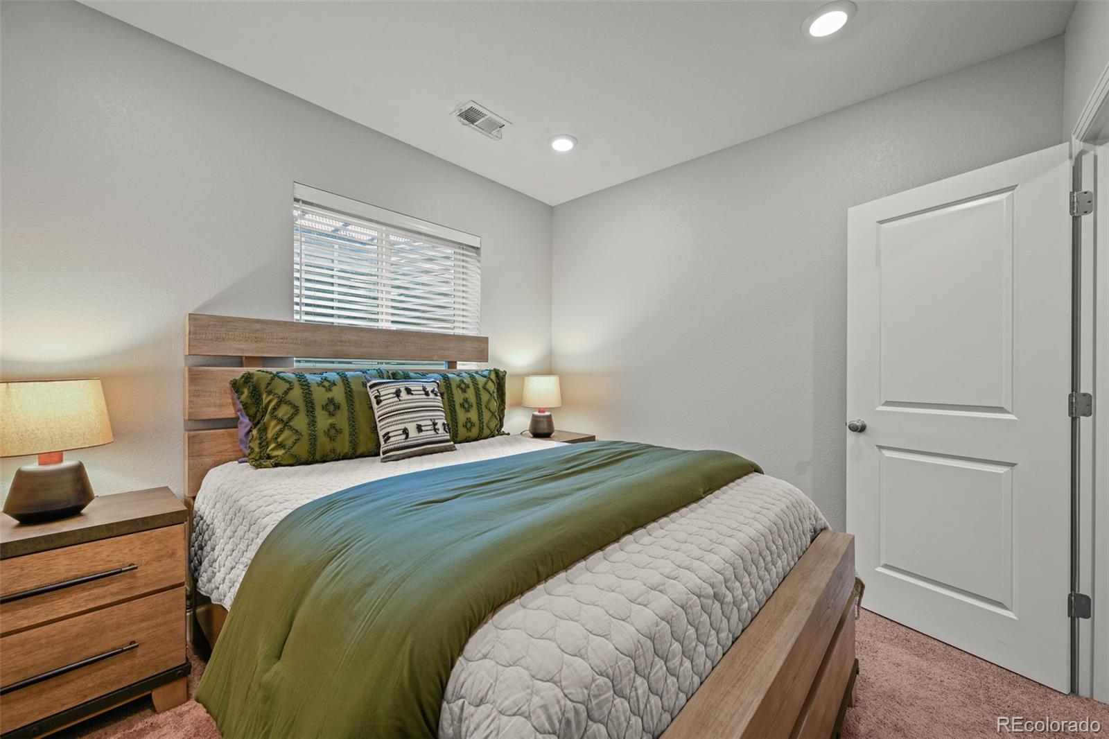 6374 North Fulton Street Denver, CO 80238 - Photo 27 of 49 a bedroom with a bed and a night stand