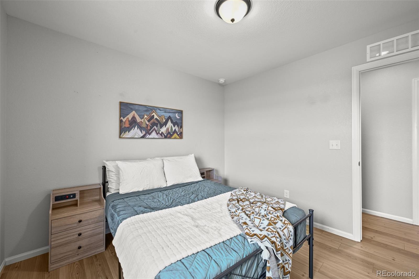 6374 North Fulton Street Denver, CO 80238 - Photo 29 of 49 a bedroom with a bed and a table in it