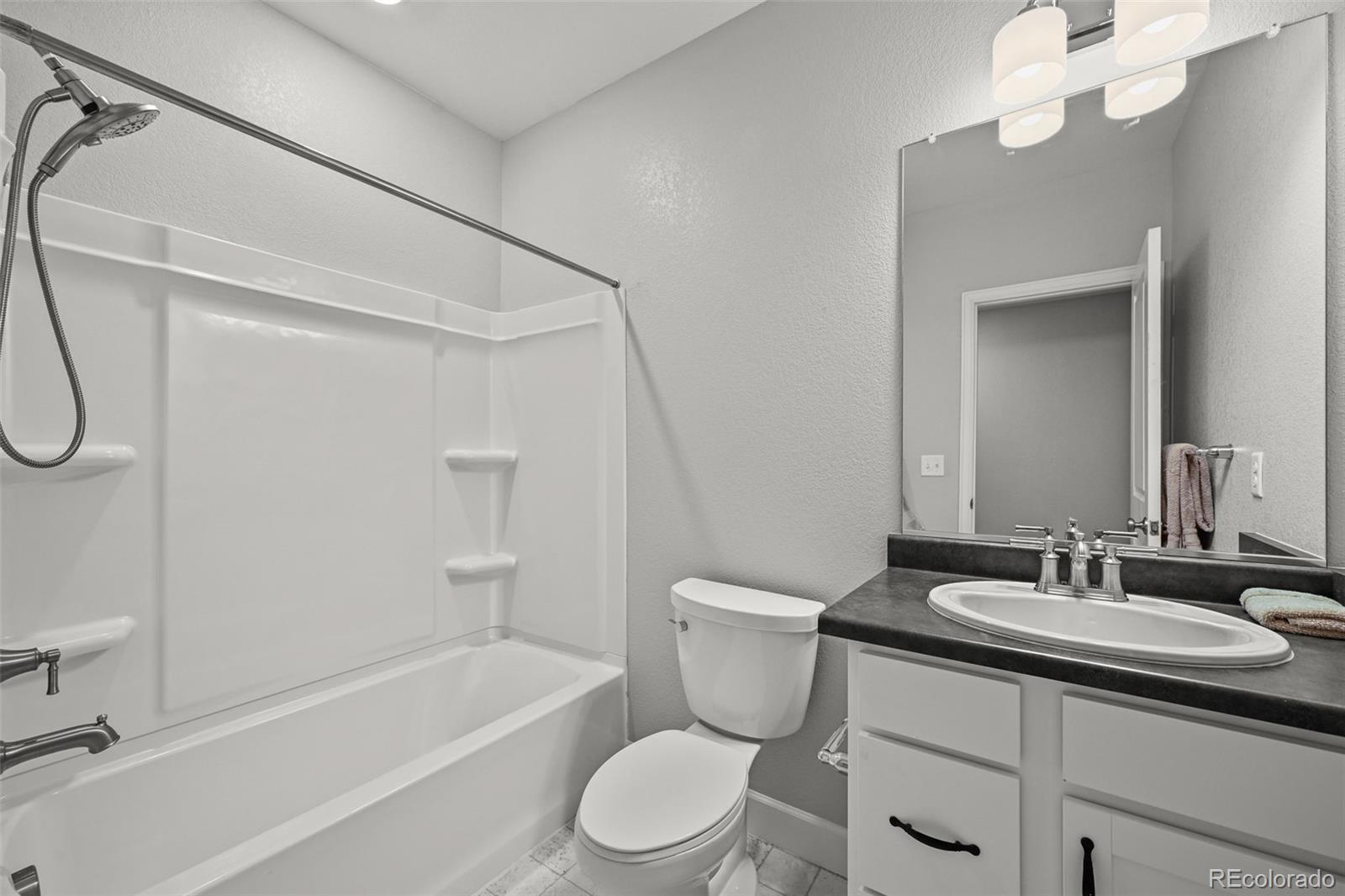 6374 North Fulton Street Denver, CO 80238 - Photo 37 of 49 a bathroom with a sink a toilet and shower