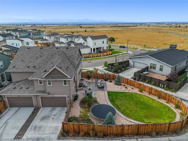 an aerial view of a house with a garden and deck