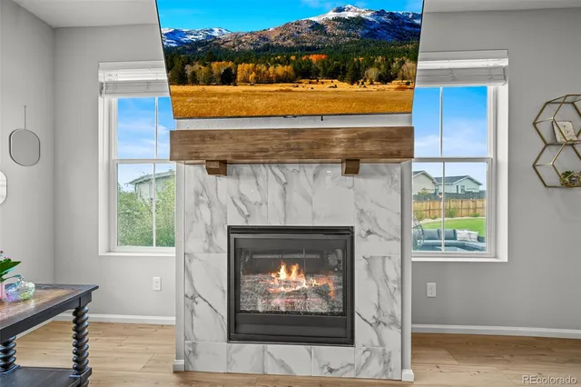 a room with fireplace and a wooden floor