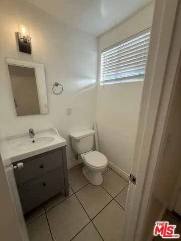 a bathroom with a toilet mirror and sink