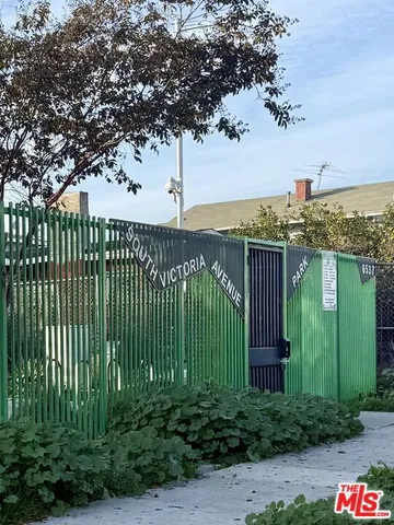 a view of a lake with a wrought fence