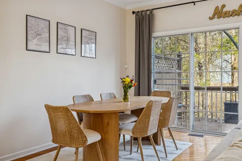 a living room with fireplace furniture and a large window