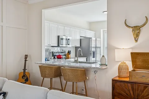 a view of a room with wooden floor and furniture