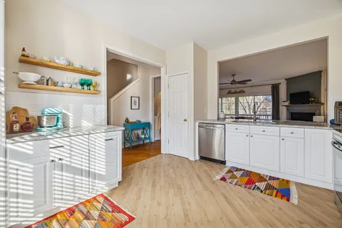 a kitchen with white cabinets and appliances