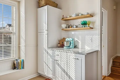 a large bedroom with a bed a flat screen tv and a couch