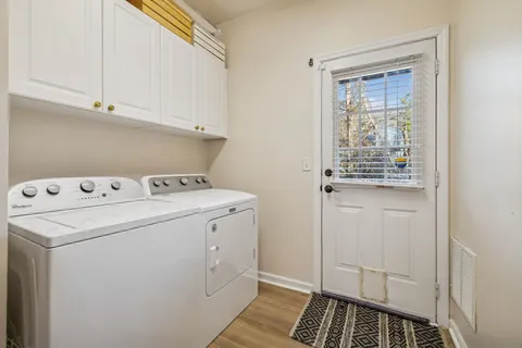 a balcony with wooden floor table and chairs