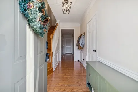 a view of a hallway with entryway and furniture