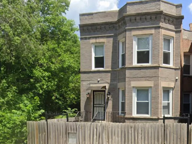 front view of a brick house with large windows