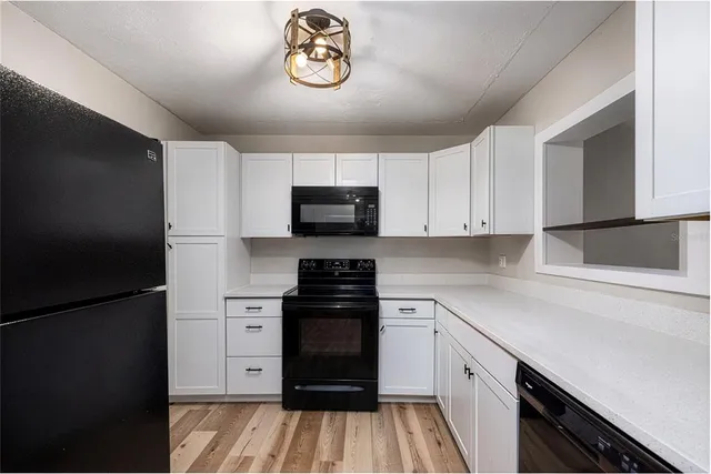 a kitchen with a refrigerator and a stove top oven