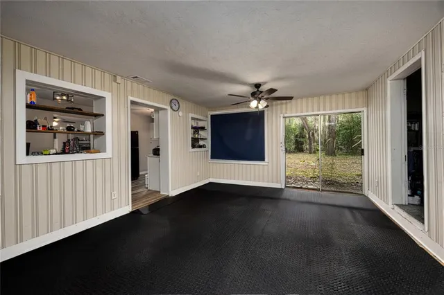a view of a big room with wooden floor garden view