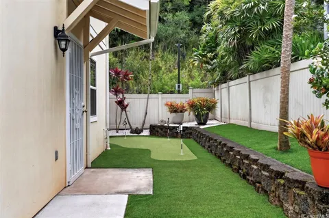 a view of backyard with a garden and trees
