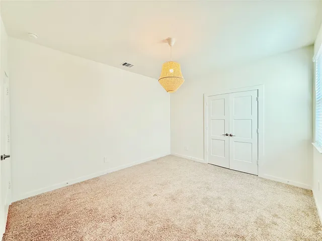 a view of a room with wooden floor and ceiling fan