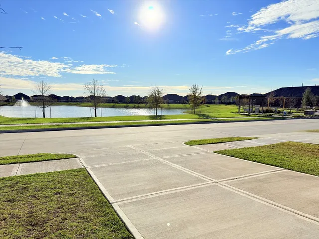 a view of a house with swimming pool and sitting area