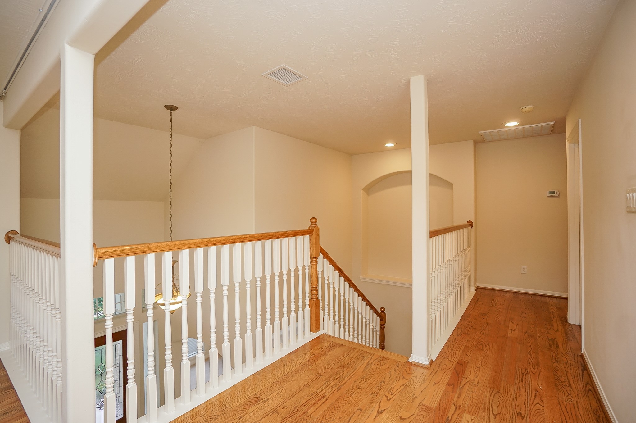 1902 Sparrows Ridge Katy, TX 77450 - Photo 20 of 48 a view of a hallway with wooden floor and staircase