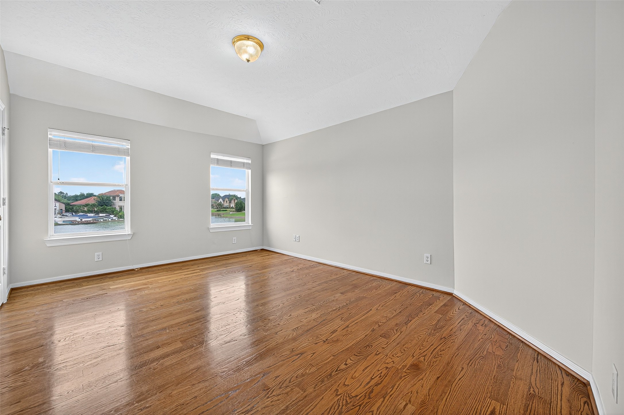 1902 Sparrows Ridge Katy, TX 77450 - Photo 26 of 48 an empty room with wooden floor and windows