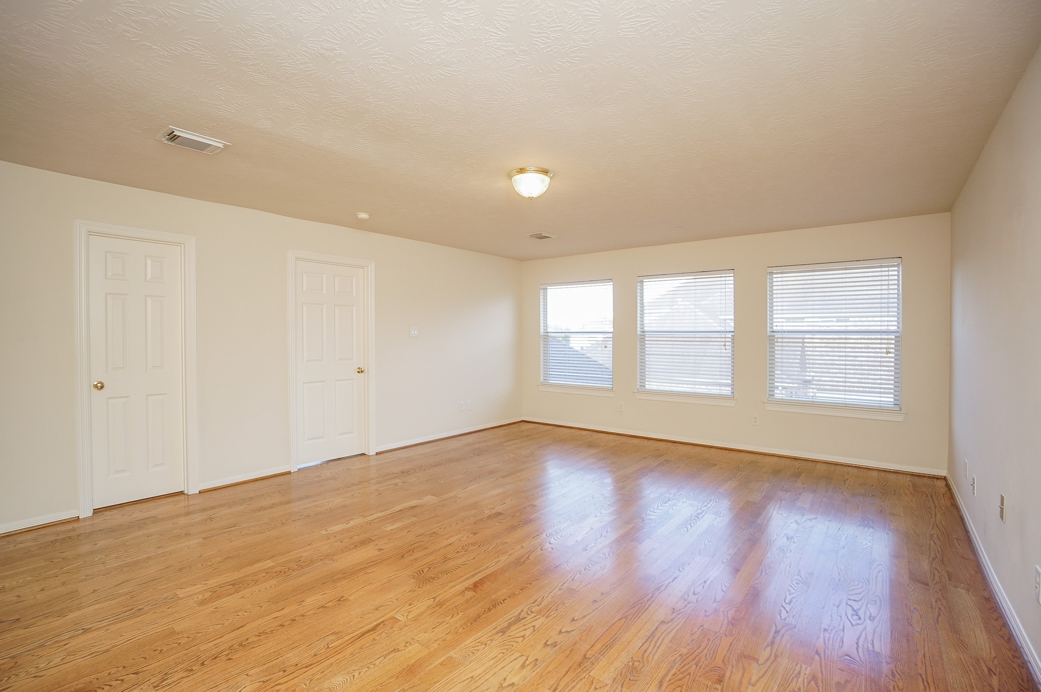 1902 Sparrows Ridge Katy, TX 77450 - Photo 27 of 48 a view of an empty room with wooden floor and a window