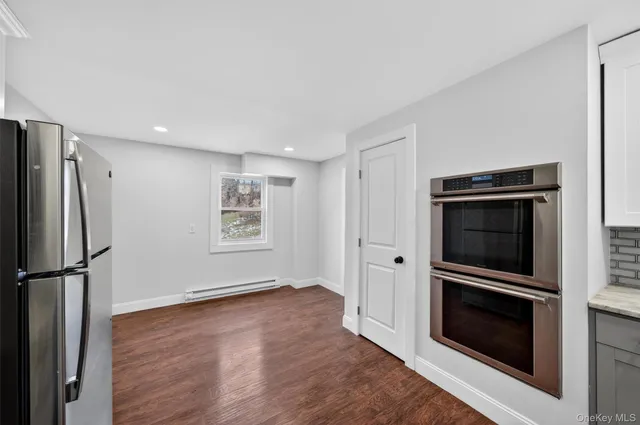 a kitchen with stainless steel appliances granite countertop a refrigerator and a sink