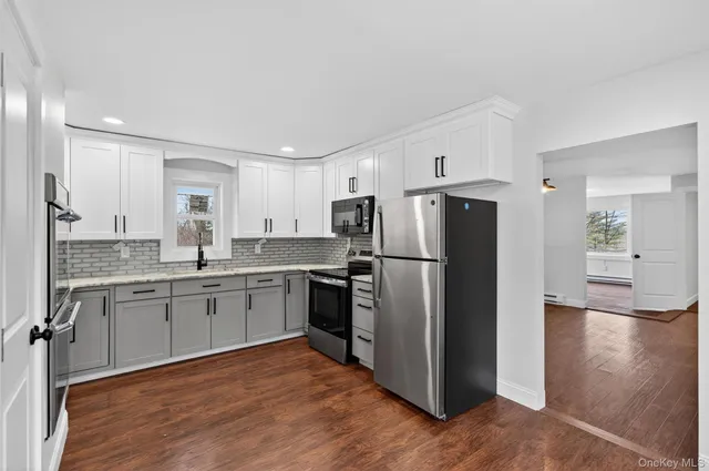 a kitchen with a refrigerator and a sink
