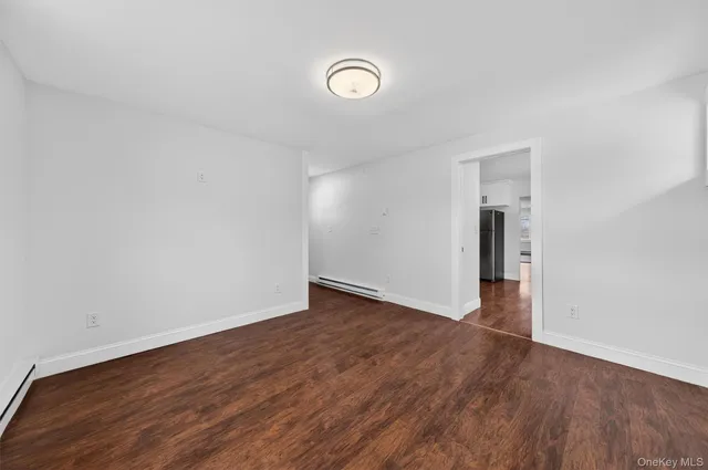 a view of a room with wooden floor and window
