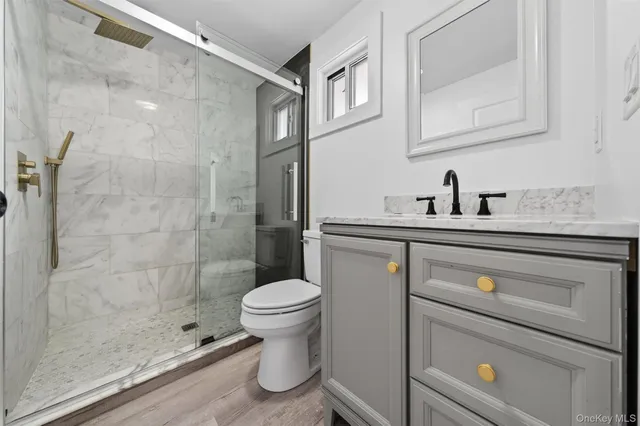 a view of a hallway with wooden floor and stairs
