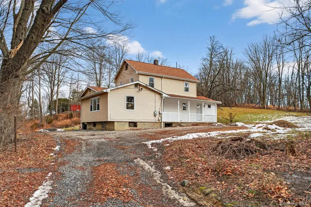 a view of a white house with a yard