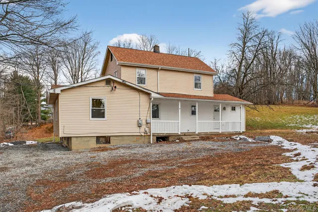 a view of a house with a yard covered in snow