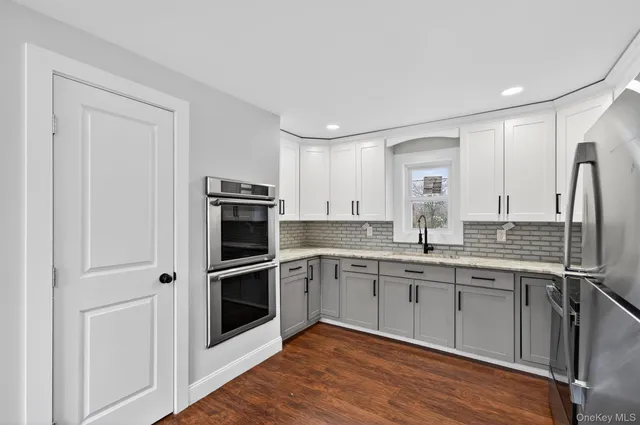 a kitchen with stainless steel appliances granite countertop a stove cabinets and microwave