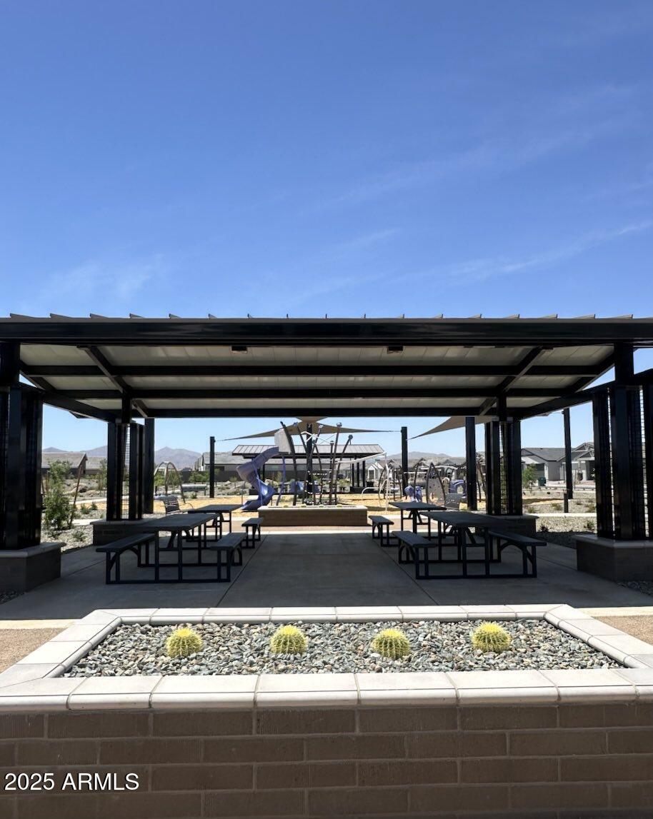 10374 North 156th Avenue Waddell, AZ 85355 - Photo 6 of 17 a view of a patio with a table and chairs