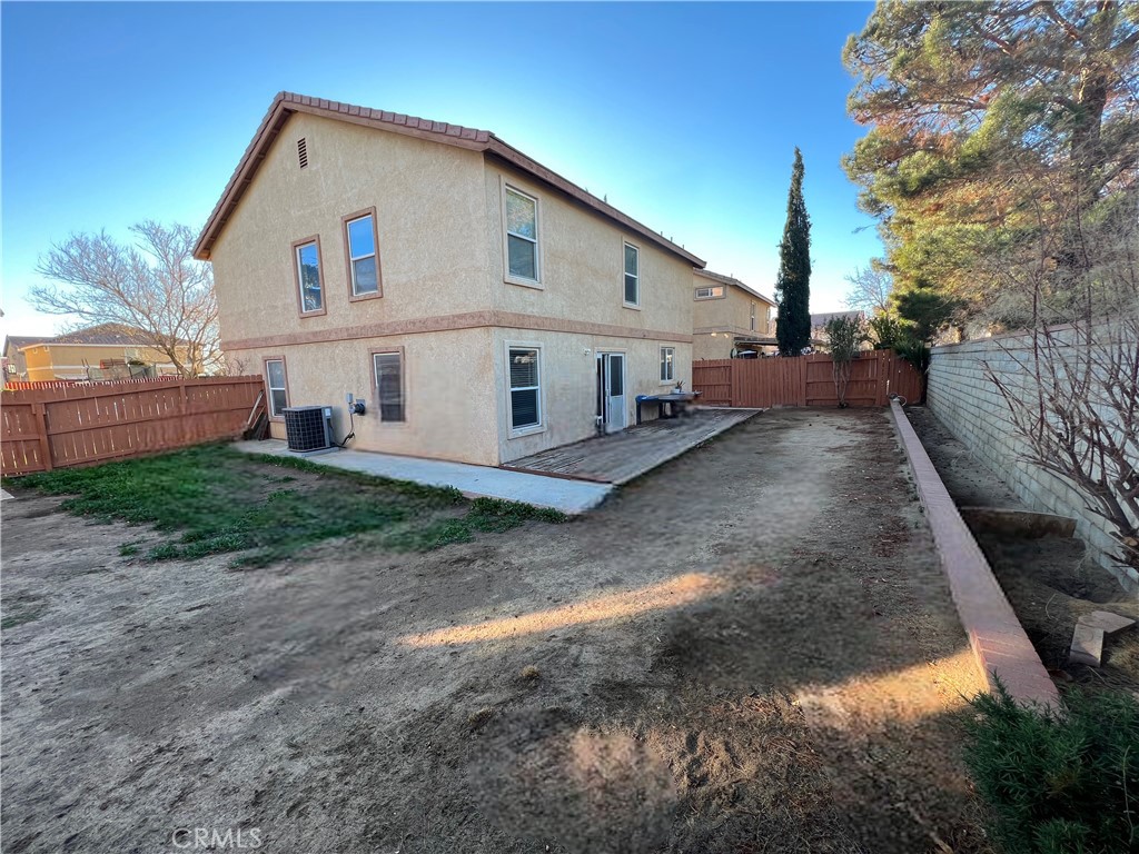 40305 Reata Road Palmdale, CA 93550 - Photo 17 of 20 a view of a white house with large trees next to a road