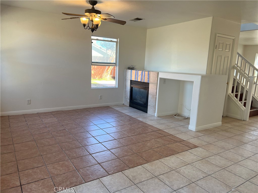 40305 Reata Road Palmdale, CA 93550 - Photo 5 of 20 an empty room with windows and fireplace