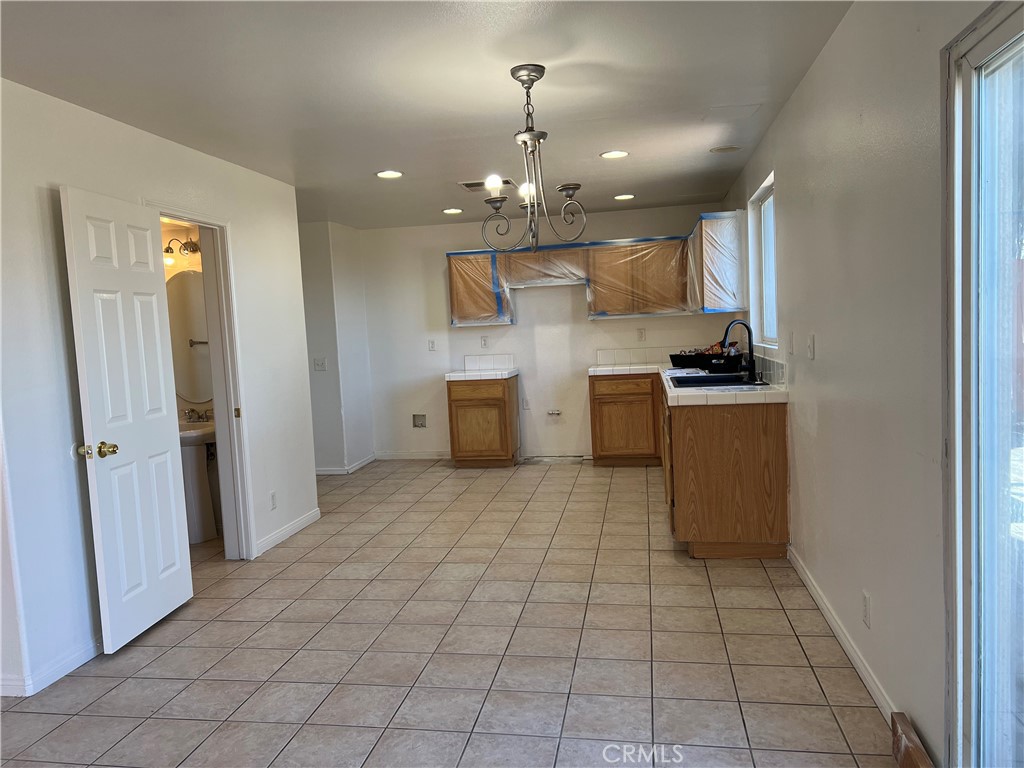 40305 Reata Road Palmdale, CA 93550 - Photo 6 of 20 a view of a kitchen with a sink and a refrigerator