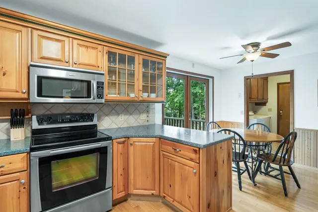 a kitchen with a stove a sink and a microwave