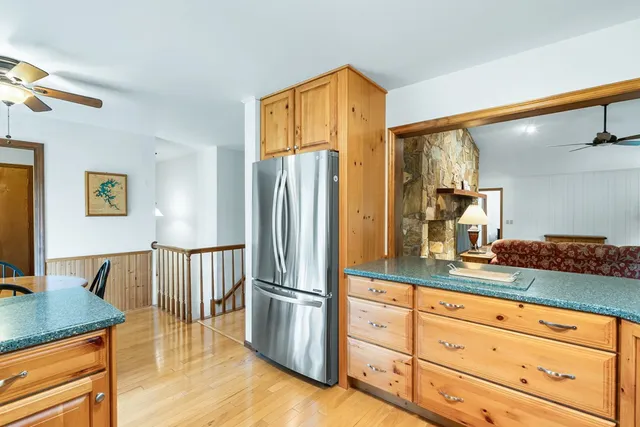 a kitchen with stainless steel appliances granite countertop a refrigerator and a stove top oven