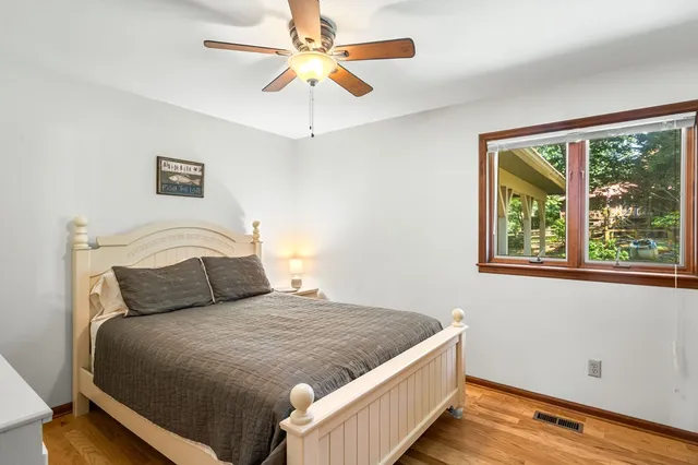 a bedroom with a bed and a window