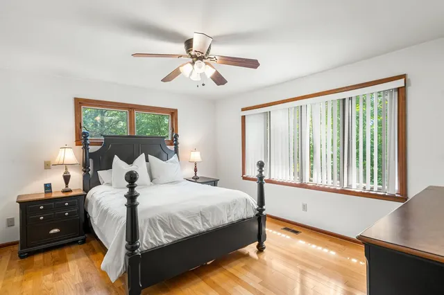 a bedroom with a large bed and a window