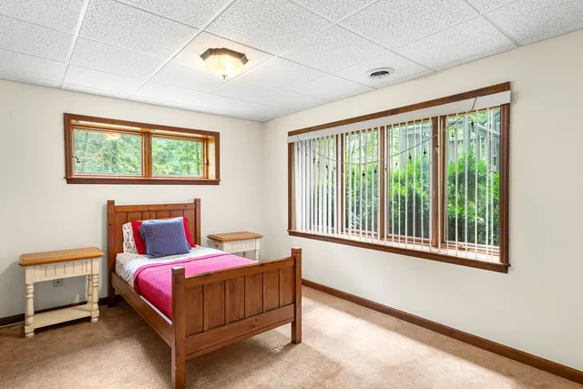 a bedroom with a bed lamp and a window