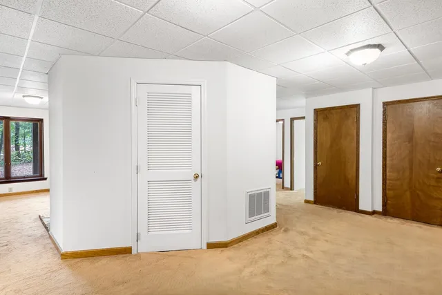 an empty room with cabinet and entryway