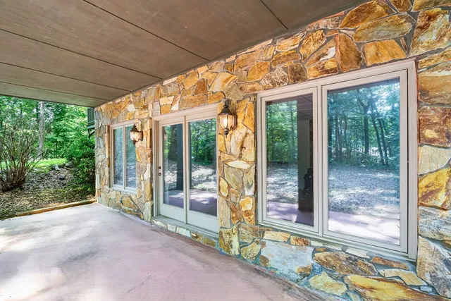 a view of backyard with large windows