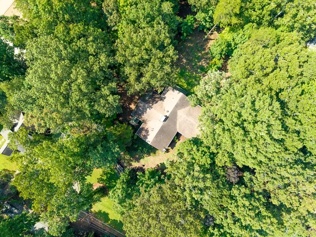 a backyard of a house with a yard and outdoor seating